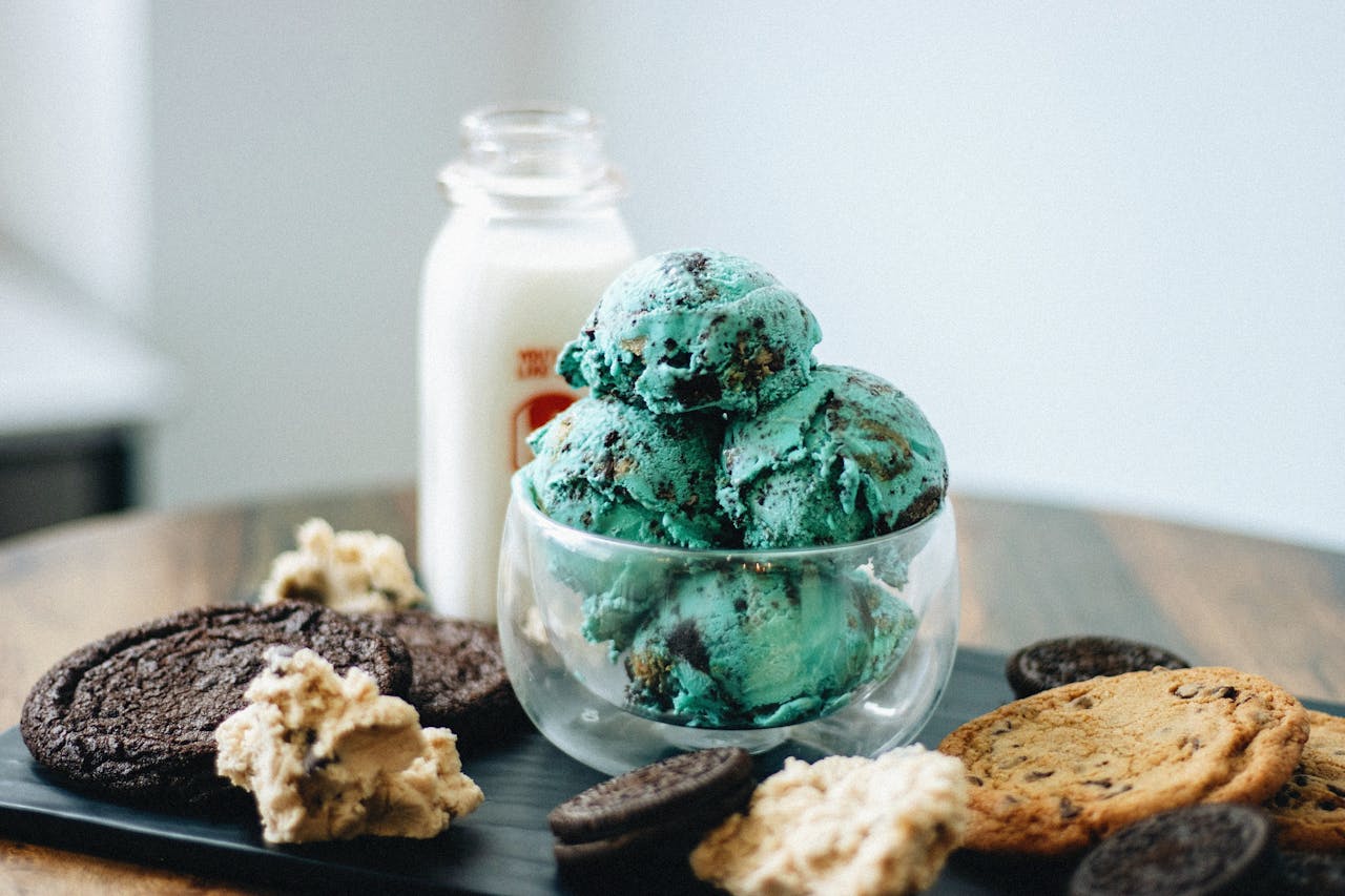 Indulge in mint chocolate chip ice cream with cookies and milk on a tray.